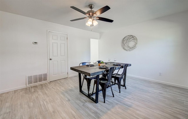 dining area with ceiling fan and light hardwood / wood-style floors