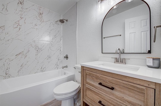 full bathroom featuring vanity, wood-type flooring, tiled shower / bath combo, and toilet