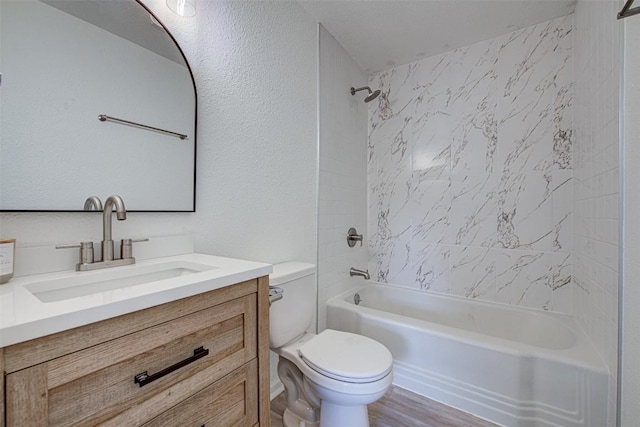 full bathroom with vanity, toilet, wood-type flooring, and tiled shower / bath combo