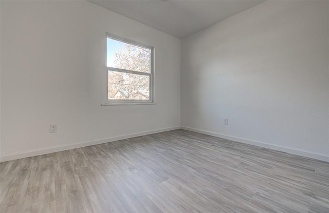 spare room with light hardwood / wood-style flooring