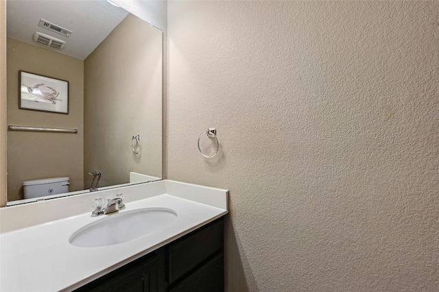 bathroom with vanity and toilet