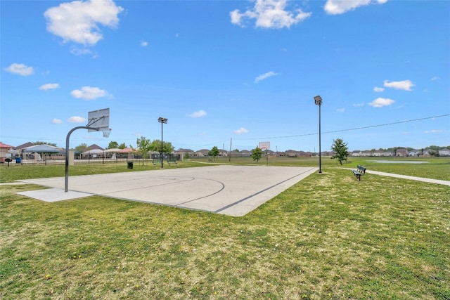 view of sport court with a yard