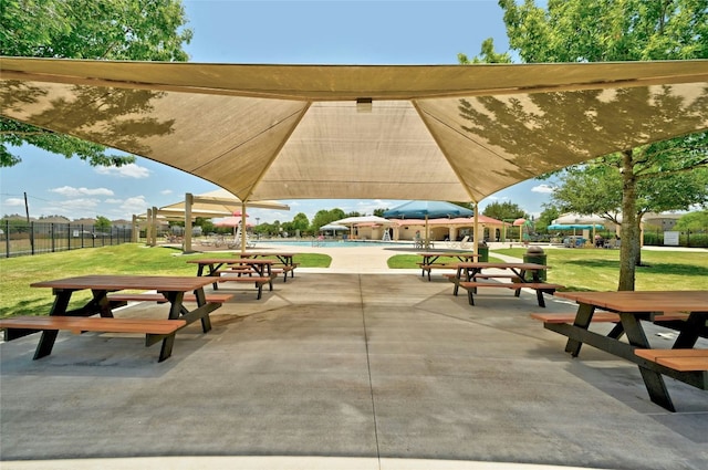 view of home's community featuring a yard, a patio area, and a swimming pool