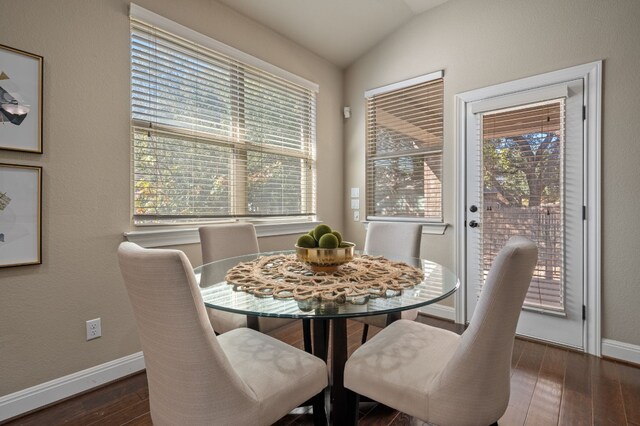 dining room featuring plenty of natural light, dark hardwood / wood-style floors, and lofted ceiling