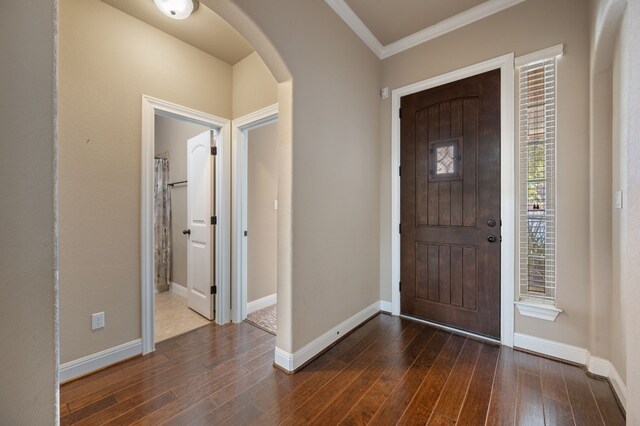 entryway with crown molding and dark hardwood / wood-style flooring