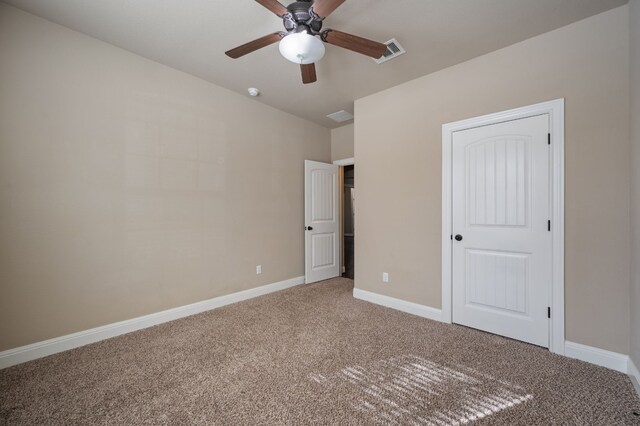 unfurnished bedroom featuring carpet flooring and ceiling fan