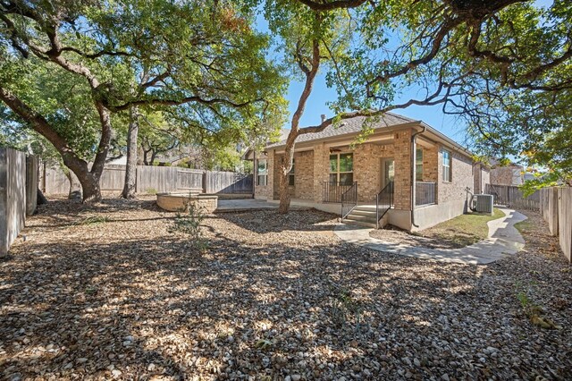 back of property featuring central AC unit