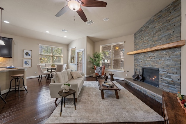 living room featuring ceiling fan, a fireplace, dark wood-type flooring, and lofted ceiling