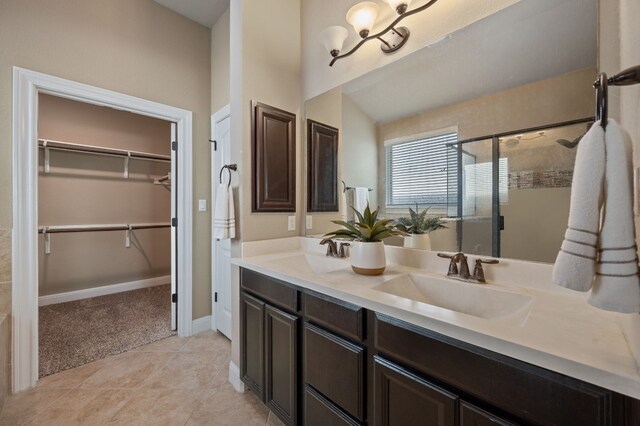 bathroom featuring tile patterned floors, vanity, and an enclosed shower