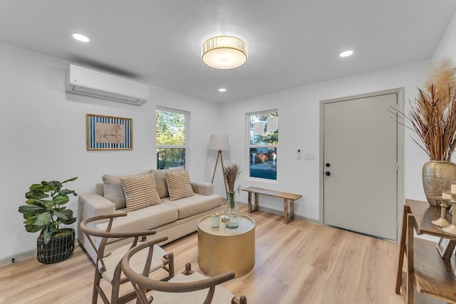 living room with light hardwood / wood-style floors and a wall mounted AC