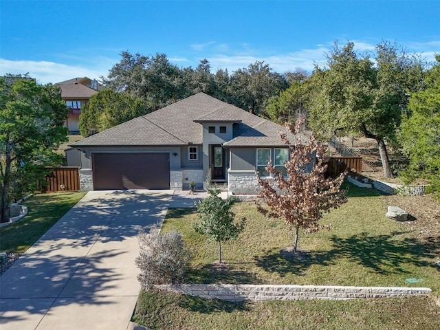 view of front facade with a front yard and a garage