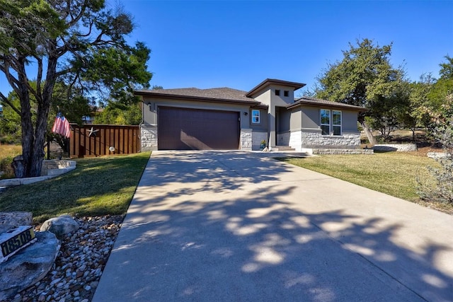 prairie-style house featuring a front yard and a garage