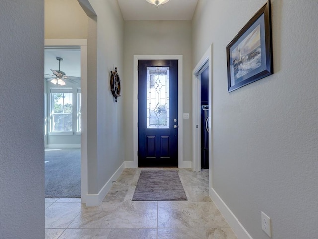 entryway featuring ceiling fan and a healthy amount of sunlight