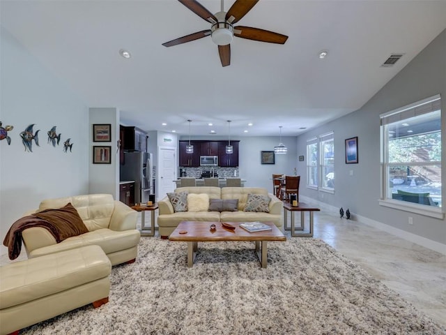 tiled living room with ceiling fan and lofted ceiling