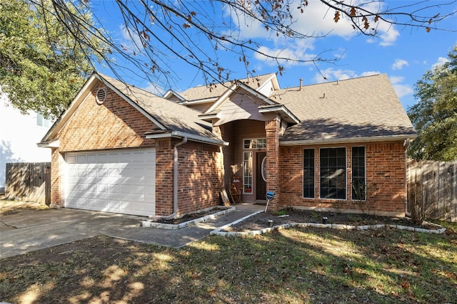 view of front of property with a front yard and a garage