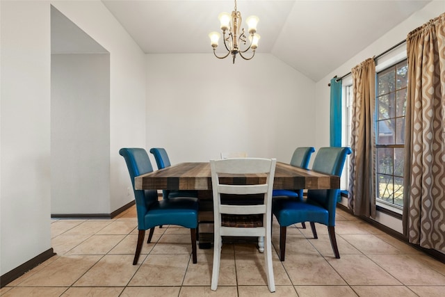 dining space featuring light tile patterned flooring, lofted ceiling, and an inviting chandelier