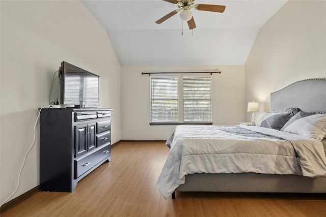 bedroom featuring light hardwood / wood-style flooring, ceiling fan, and lofted ceiling