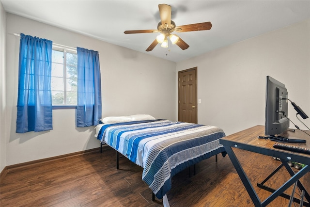 bedroom with ceiling fan and dark wood-type flooring