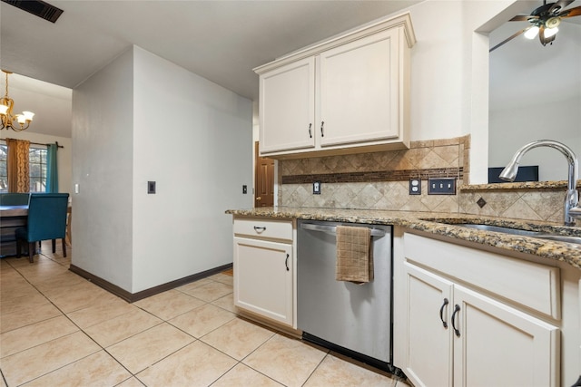 kitchen featuring ceiling fan with notable chandelier, sink, stainless steel dishwasher, light stone countertops, and tasteful backsplash