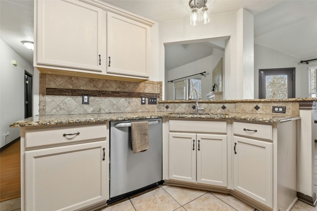 kitchen with light stone countertops, sink, stainless steel dishwasher, backsplash, and kitchen peninsula