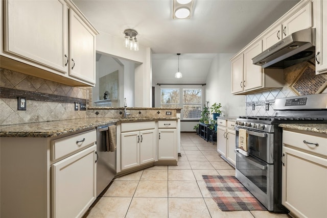 kitchen featuring hanging light fixtures, sink, light tile patterned floors, appliances with stainless steel finishes, and light stone counters