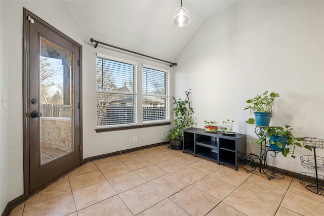 entryway with light tile patterned floors and vaulted ceiling