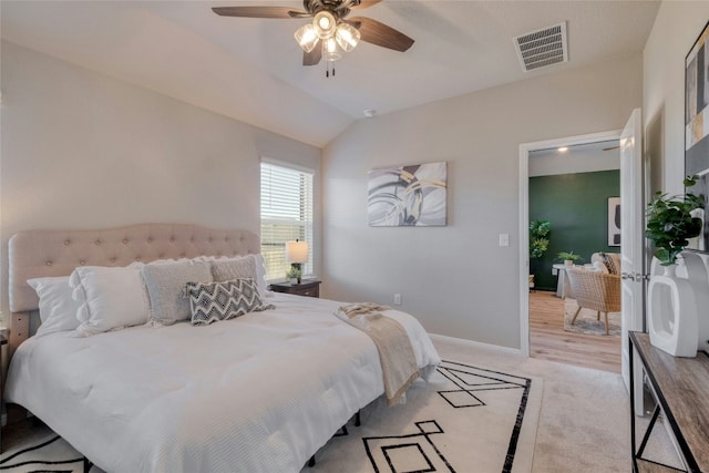 bedroom featuring ceiling fan, light carpet, and lofted ceiling