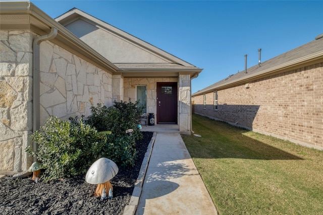 doorway to property with a yard