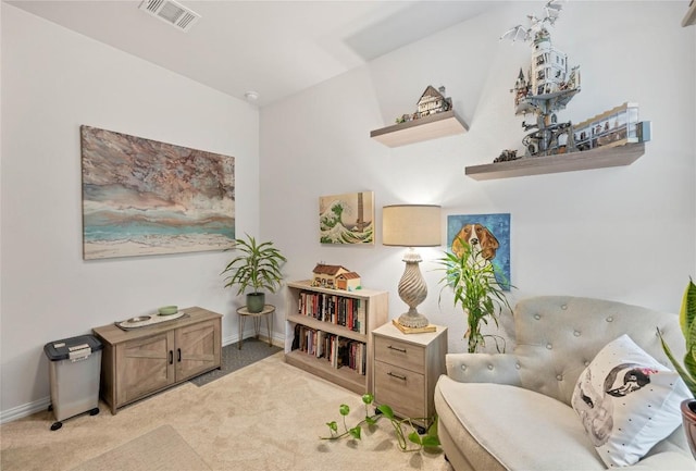 living area featuring light carpet