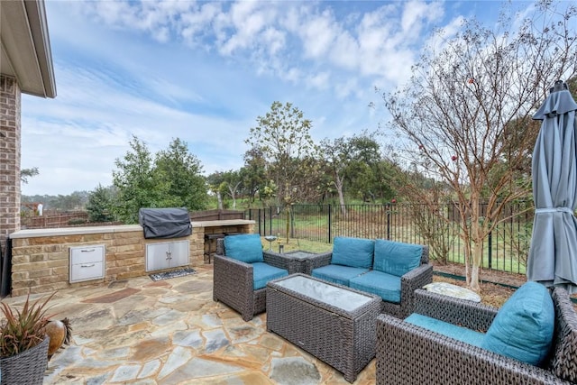 view of patio featuring an outdoor kitchen, area for grilling, and outdoor lounge area