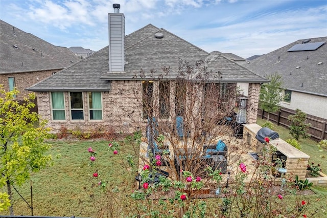 rear view of house with a lawn