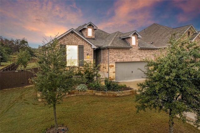 view of front of home featuring a yard and a garage