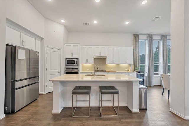 kitchen featuring white cabinetry, an island with sink, appliances with stainless steel finishes, and sink