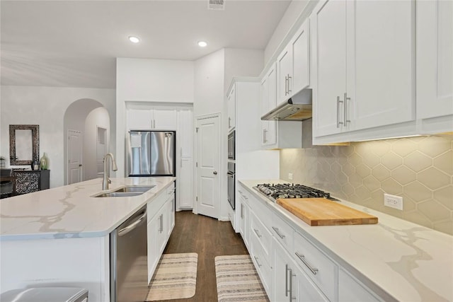 kitchen featuring light stone countertops, stainless steel appliances, sink, and white cabinets