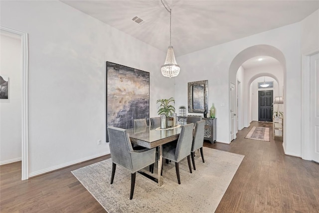 dining area featuring dark wood-type flooring