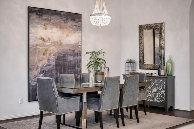 dining space with an inviting chandelier and hardwood / wood-style floors