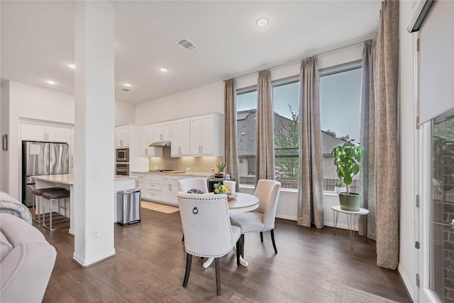 dining space featuring dark wood-type flooring