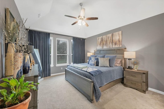 carpeted bedroom featuring ceiling fan and vaulted ceiling