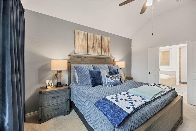 bedroom featuring light carpet, ensuite bath, high vaulted ceiling, and ceiling fan