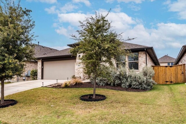 view of front of house with a front lawn and a garage