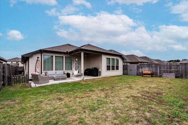 back of property with an outdoor hangout area, a patio, and a yard