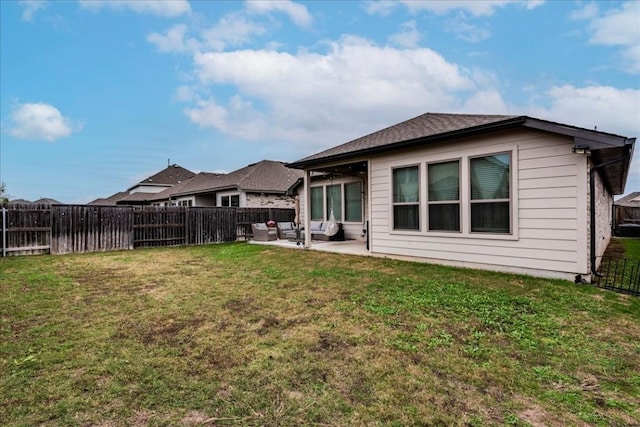 back of house with a lawn and a patio area