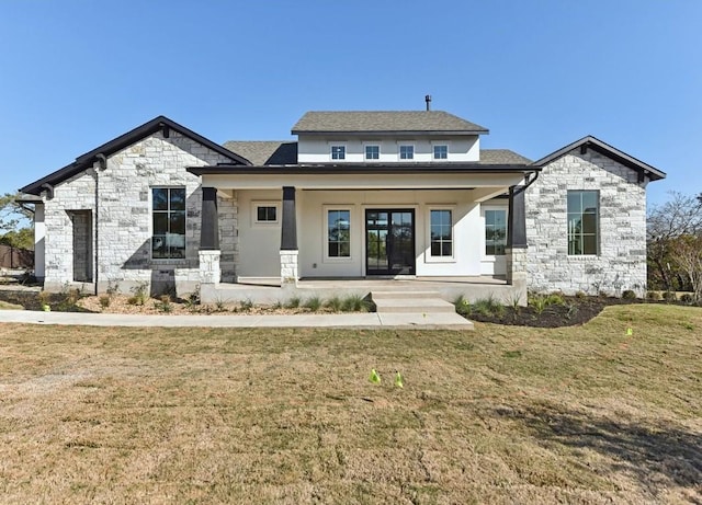 265 Gaucho Way, Dripping Springs, TX 78620 - view of front of home featuring stone siding, a porch, and a front yard