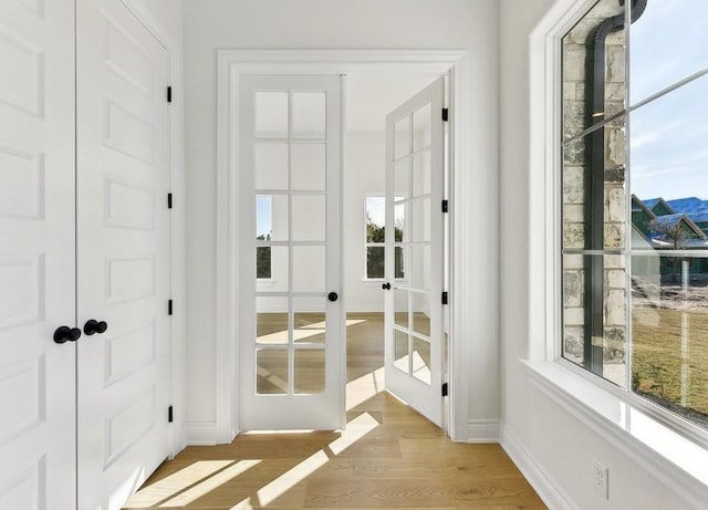 doorway to outside with french doors and light hardwood / wood-style flooring