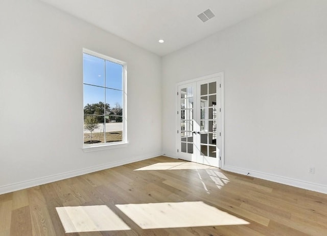 265 Gaucho Way, Dripping Springs, TX 78620 - spare room featuring french doors, wood finished floors, baseboards, and recessed lighting