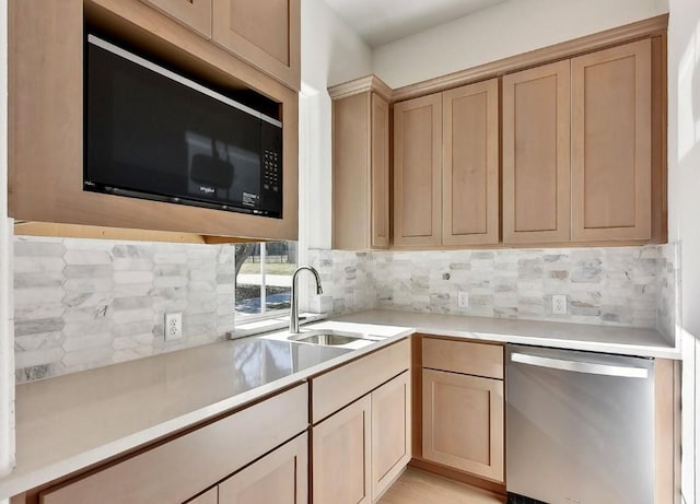 kitchen with black microwave, sink, stainless steel dishwasher, backsplash, and light brown cabinetry