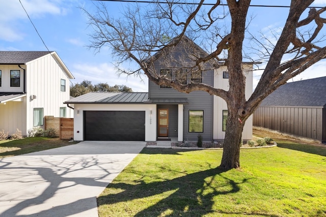 view of front of house with a front yard and a garage