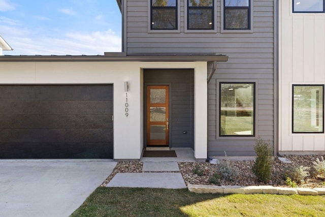 doorway to property with a garage