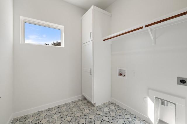 washroom featuring washer hookup, electric dryer hookup, and cabinets