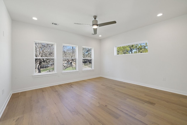 unfurnished room with light wood-type flooring and ceiling fan